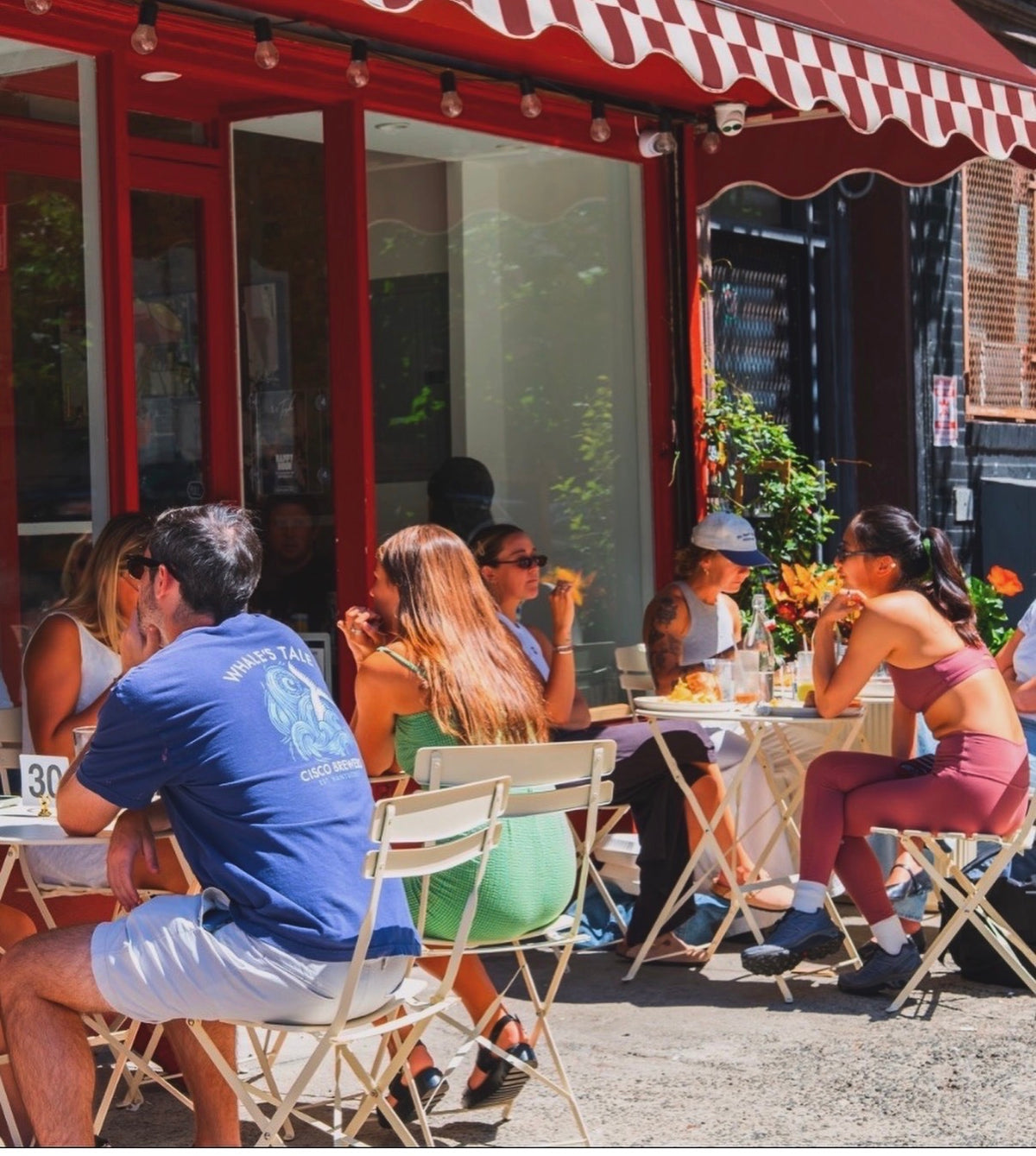 Friends enjoying drinks at LeTish’s outdoor sidewalk tables